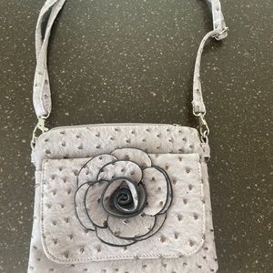 A small lavender cross body bag.